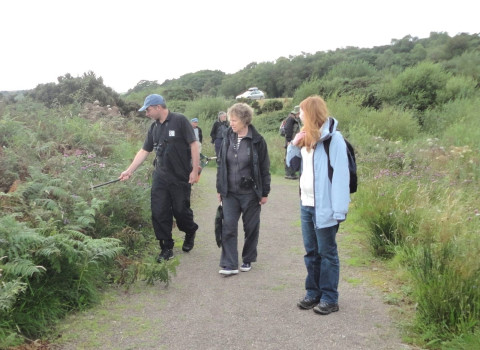 Checking pathside vegetation for damselflies ©Jim Logan